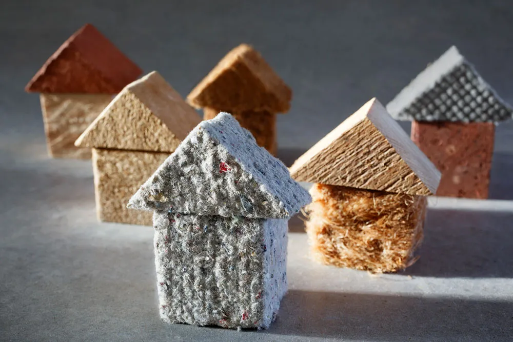 Models of houses made from various insulation materials, representing eco-friendly options for energy-efficient insulation solutions in Western Australia.